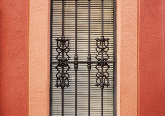 forged lattice on a red wall