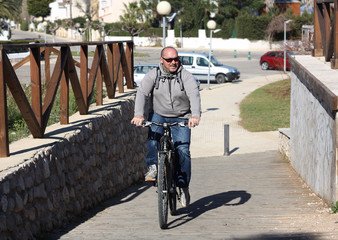 Elderly man on a bicycle.