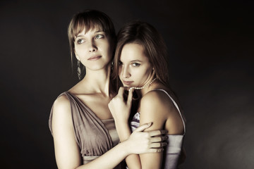 Two young beautiful women embracing