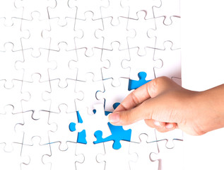 Young girl hand playing jigsaw puzzle