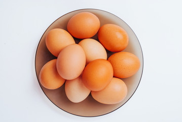 Lot of eggs on the plate, top view