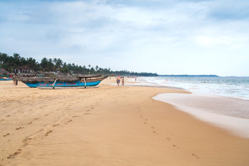 Tourists enjoys walking and swimming at Hikkaduwa beach