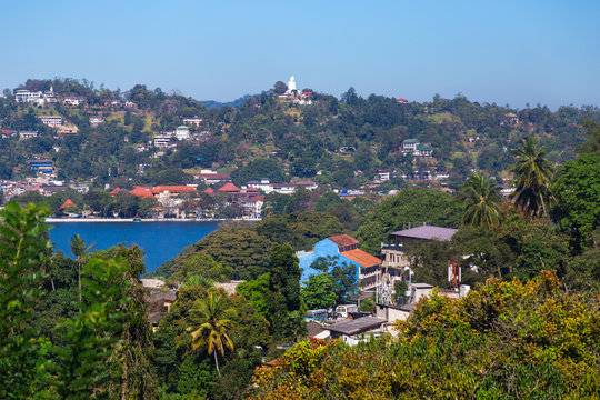 View on Kandy lake and city buildings
