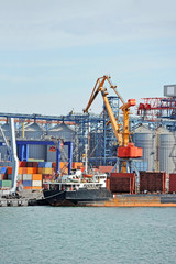 Bulk cargo ship under port crane bridge, Odessa, Ukraine