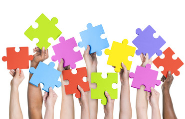 Human hands holding jigsaw puzzle