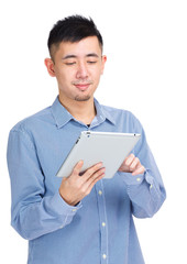 Asian man looking at tablet