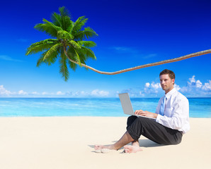 Businessman Working with Laptop on Beach
