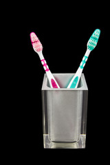 Two tooth brushes in a semi transparent container
