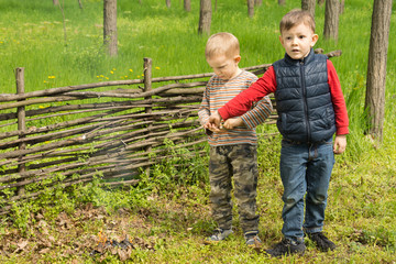 Young boy pointing excitedly to a small fire