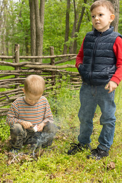 Two Young Boys Learning Survival Skills