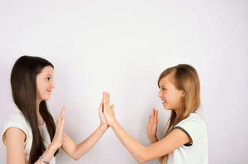 two girls claping palms
