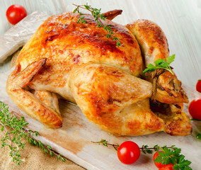 Roasted chicken on wooden table