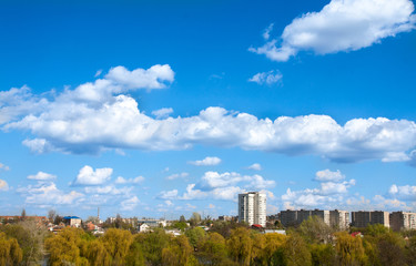 blue sky with field of green grass and city on the horizon
