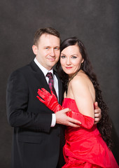 Portrait of happy couple in love posing at studio on background