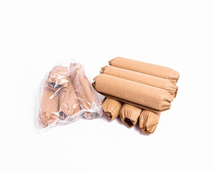 An arrangement of cylindrical objects wrapped and ready to be shipped against a white background.