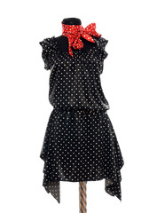 Polka dots dress with red scarf on mannequin. Tailor's dummy.