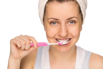 Girl with braces brushing teeth isolated