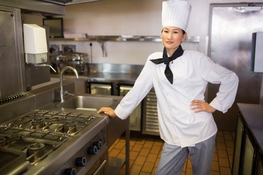 Smiling female cook in the kitchen