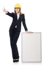 Pretty businesswoman with hard hat and  blank board  isolated on