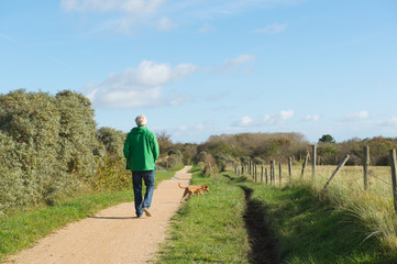 Man walking dog in nature