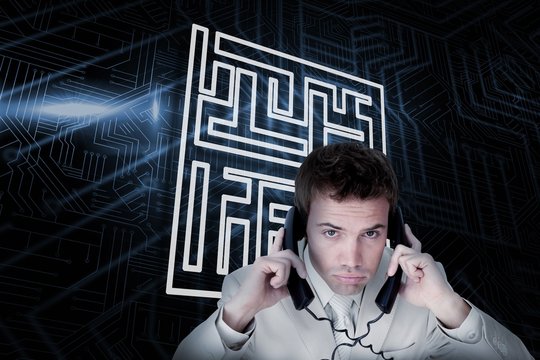 Composite image of maze and businessman tangled in wires