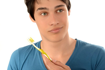 Man with beautiful teeth smiling and holding a toothbrush.