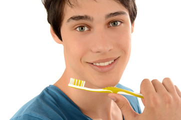 Man with beautiful teeth smiling and holding a toothbrush.