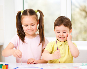 Children are painting with paint