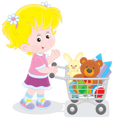 Girl with a shopping trolley of toys