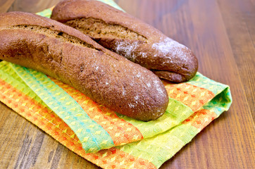 Rye baguettes on a napkin and board