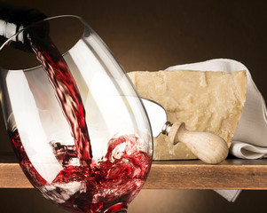 Still life with parmesan  and red wine  on the wooden table