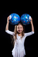 Happy little girl posing with gymnastic balls