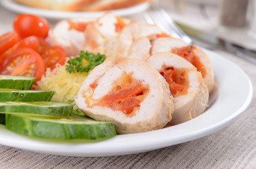 Delicious chicken roll on plate on table close-up