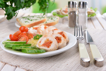 Delicious chicken roll on plate on table close-up