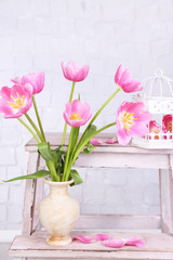 Beautiful pink tulips on grey wall background