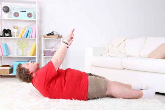 Large Fitness Man Working Out  At Home