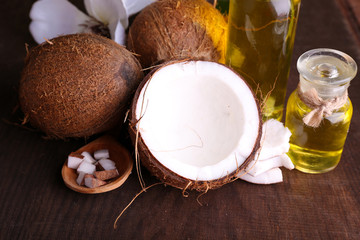Coconuts and coconut oil on wooden table