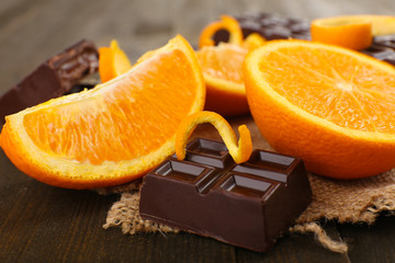 Chocolate and orange on wooden table