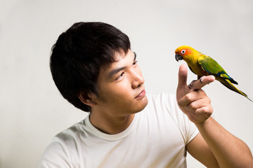 Asian men with parrot - Sun Conure - 64191838