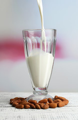 Almond milk is poured into glass,
