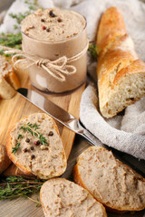 Fresh pate with bread on wooden table