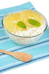 Bowl of tasty cottage cheese with pineapple, isolated on white