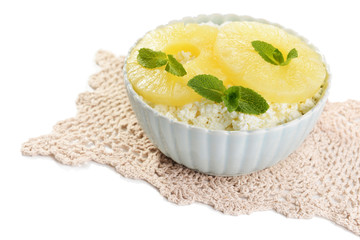Bowl of tasty cottage cheese with pineapple, isolated on white