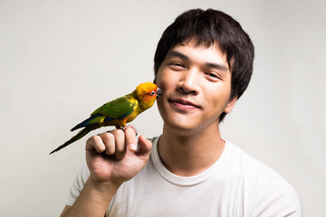 Asian men with parrot - Sun Conure - 64192661