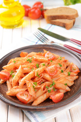 Pasta with tomato sauce on plate on table close-up
