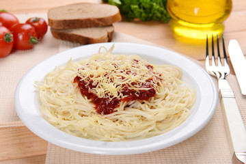 Pasta with tomato sauce on plate on table close-up