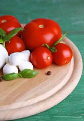 Composition with tasty mozzarella cheese balls, basil and red