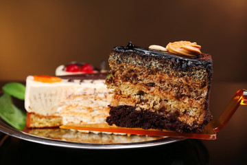Assortment of pieces of cake, on dark background © Africa Studio