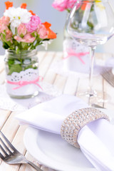 Beautiful table setting with spring flowers in jar close-up