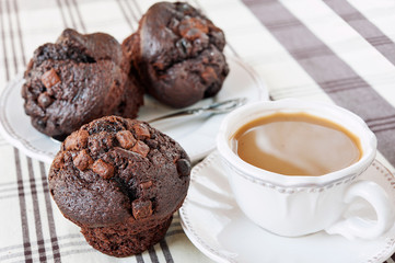 Homemade chocolate muffins/buns with cup of coffee. Still life